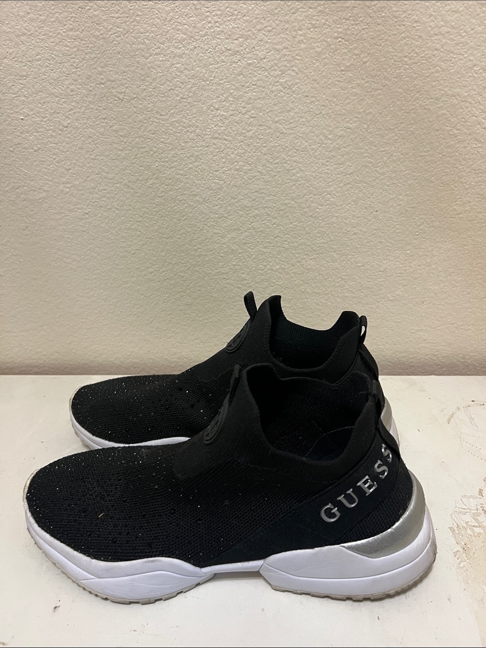GUESS Women’s Black Knit Slip-On Sneakers with White Sole and Silver Accent